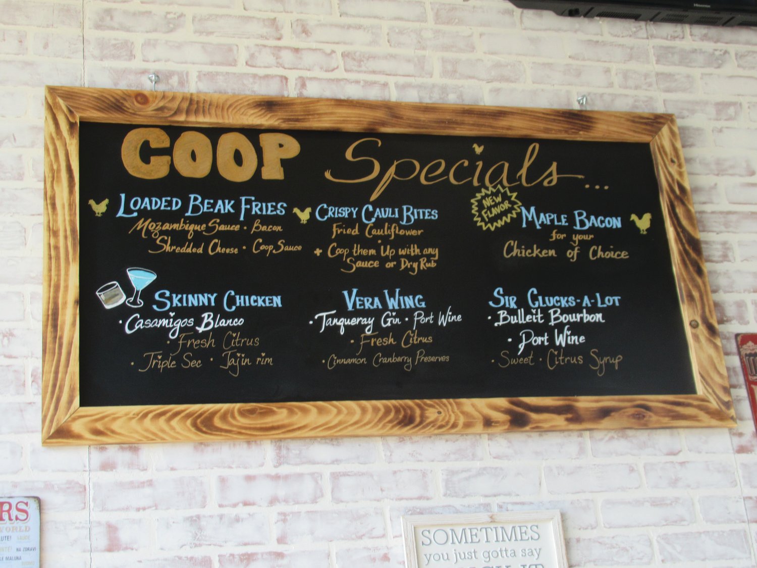 SJUPER SIGN: This chalkboard menu of The Coop’s signature specials is an example of the unique wall-hangings inside Johnston’s new eatery.